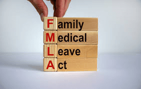 A person is stacking blocks with the words fmla.